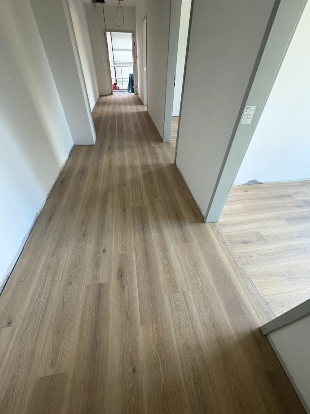 Heller Laminatboden im Flur ohne Sockelleisten, frisch verlegt (Laminat verlegen)